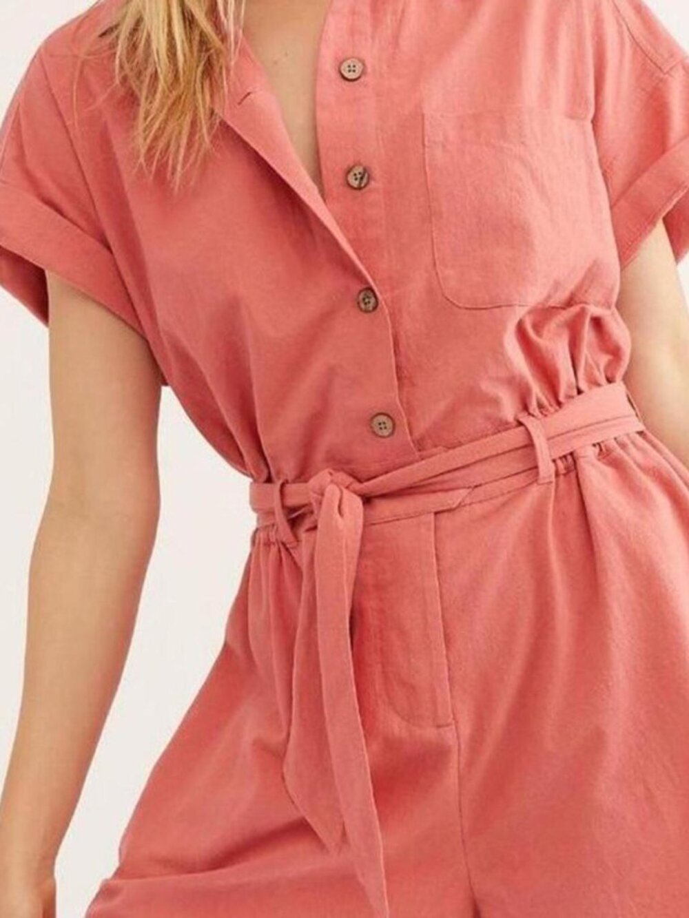 Free People cotton utility romper featuring a button-down front and belted waist